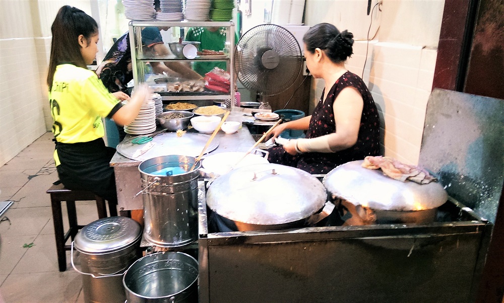 Making banh cuon (mushroom-filled steamed rice pancakes) at Banh Cuon Gia Truyen in Hanoi