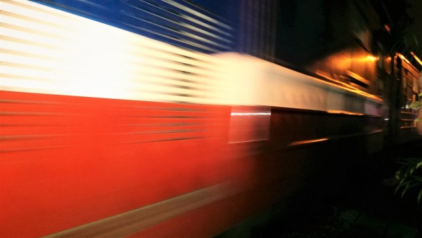 A train travelling through Train Street in Hanoi at super fast speeds