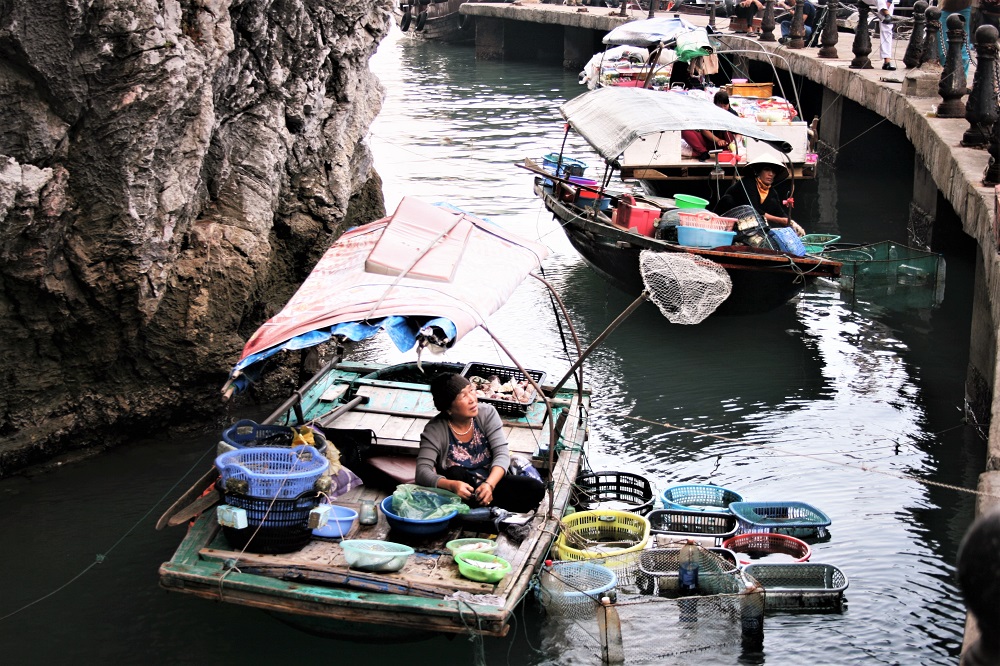 A floating market outside a cave in Halong Bay