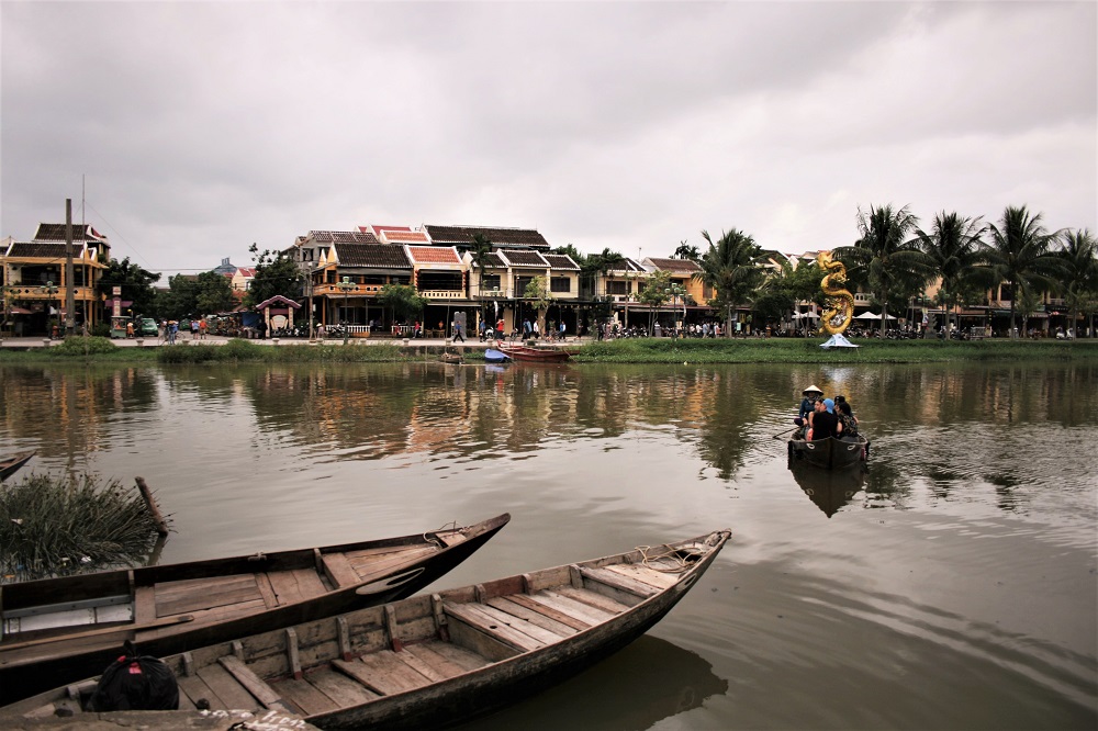 Boats line the riverfront in the port of Hoi An