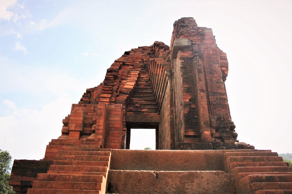Looking up at a red brick temple in My Son 