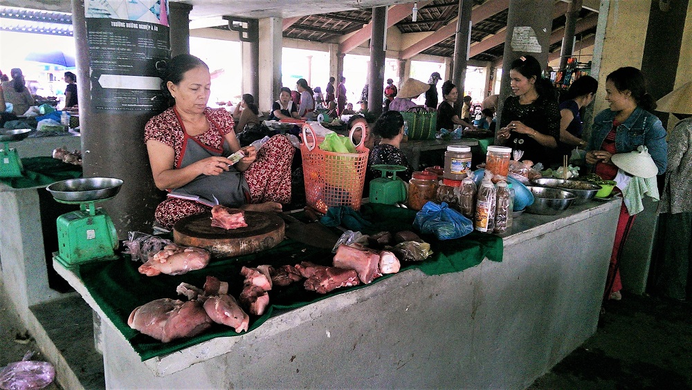 A woman selling meat in a market in the village of Thuy Thanh outside Hue