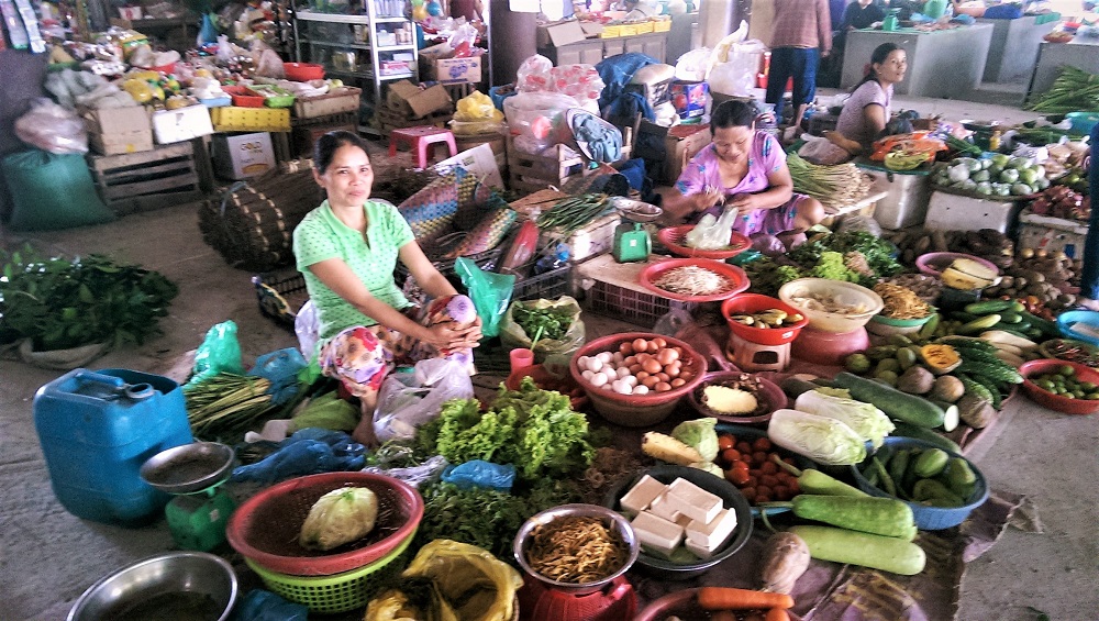 A woman selling vegetables and eggs in the market in the village of Thuy Thanh just outside Hue