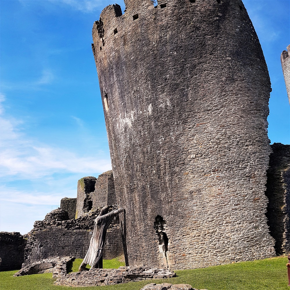 Statue holding up the leaning tower at Caerphilly Castle