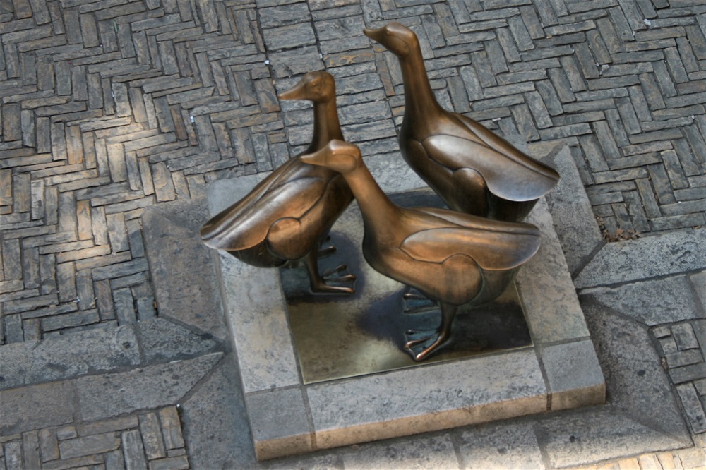 A bronze statue of three geese in Sarlat-la-Canéda