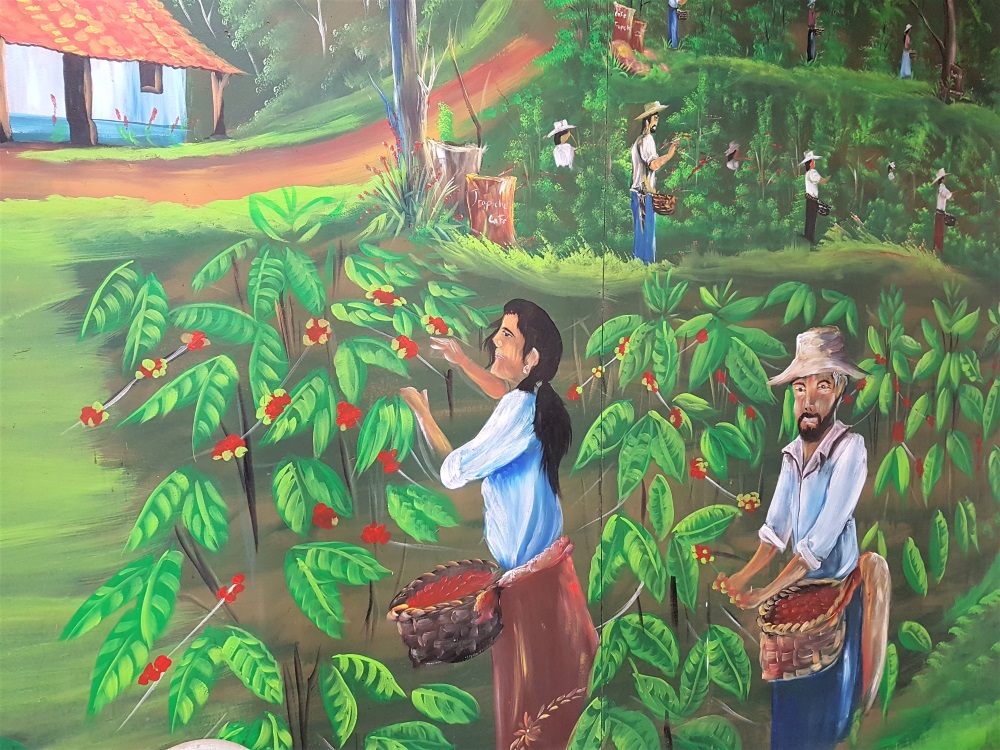Mural of people picking coffee berries at El Trapiche farm in Costa Rica