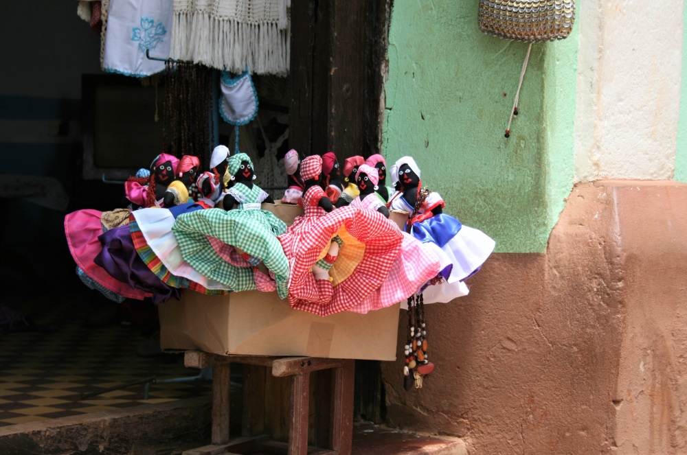 Fabric dolls for sale in a box outside a shop in Trinidad, Cuba