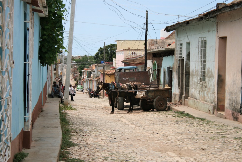 A horse and cart in the middle of a street in Trinidad, Cuba