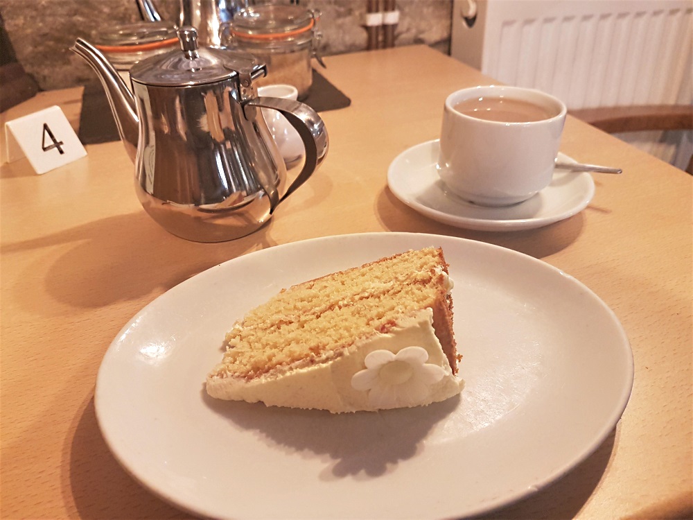 Lemon and elderflower cake, and a pot of tea, at The White Monk Gift Shop and Tea Room in Tintern