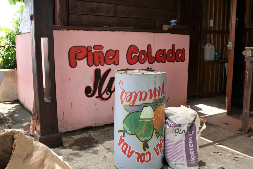 Brightly coloured pina colada signs in Cuba