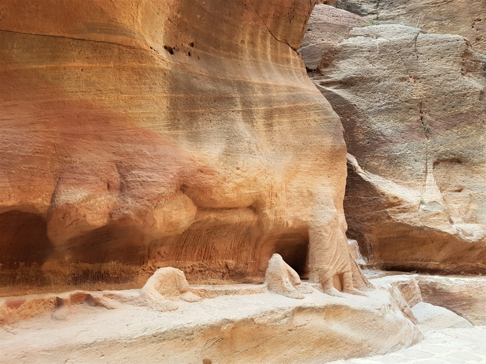 The remains of the carving of a man and his camels in the Siq in Petra