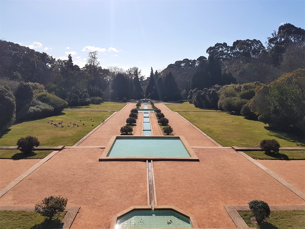 Perfectly manicured gardens beside the pink art deco-style house in the grounds of the Casa de Serralves contemporary art museum in Porto