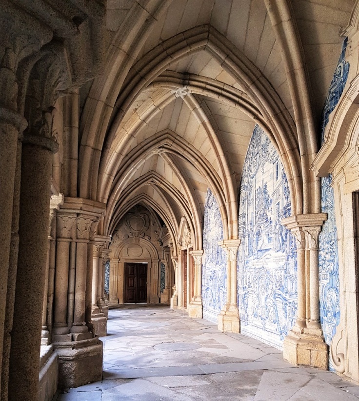 Blue and white azulejos (tiles) depicting stories from the Bible adorn the walls of the Se Cathedral's cloisters in Porto