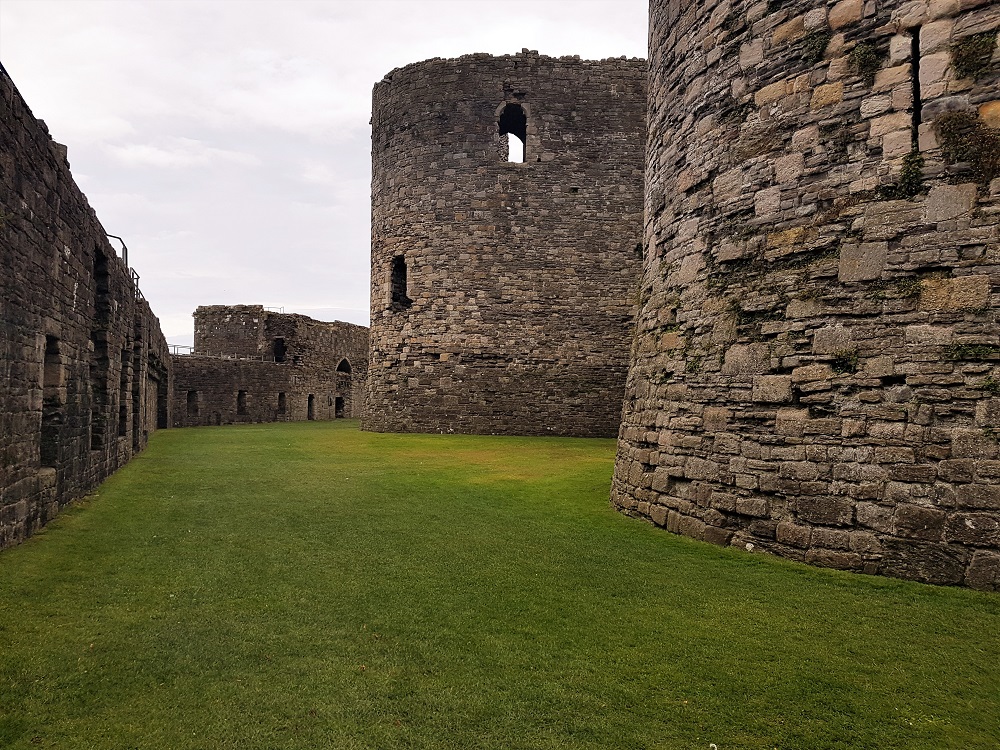 The grassy moat between the inner and outer parts of Beaumaris Castle