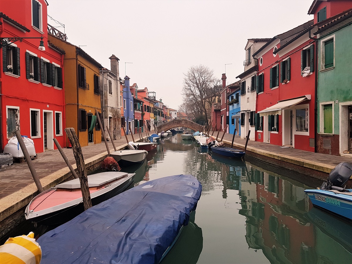 Colourful houses line a canal in Burano
